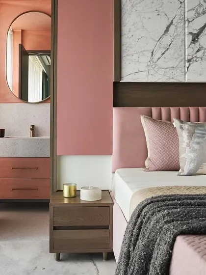 This master bedroom in the Whimsical House was designed as a youthful yet serene retreat. I combined soft pastel pinks and greens with the texture of dyed ash grey wood and the elegance of Satvario marble to create a harmonious and cozy personal space.