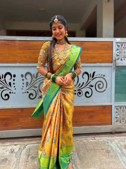 The smile of a happy client says it all. She looks radiant in our yellow Kanchipuram silk saree, a perfect choice for bringing brightness and tradition to any celebration.