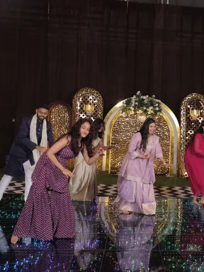 A group of friends lights up the mirrored dance floor with their performance. We ensure our choreography works beautifully with the event's staging and lighting for maximum visual impact.