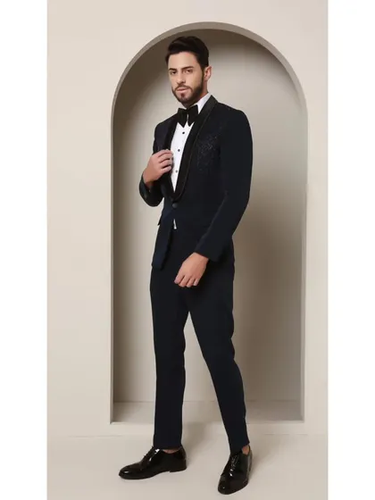Teal never looked so sharp. This image highlights the classic satin collar of the Prism Riviera tuxedo, which provides a smooth contrast to the captivating geometric glass bead design on the upper chest.