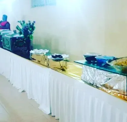 A full view of a cleanly arranged buffet line in a hall. I ensure the layout is logical and visually appealing for guests.