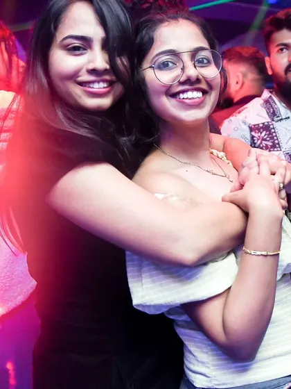 Two friends sharing a happy moment while dancing. These are the connections that make a night special.