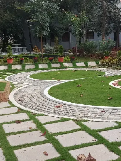 Intricate paving patterns create circular motifs in this public park's lawn. This demonstrates my ability to execute complex hardscape designs.