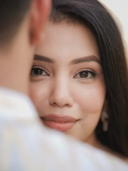 A beautiful over-the-shoulder shot focusing on the bride's expressive eyes. This pre-wedding portrait is all about capturing that loving, intense gaze.