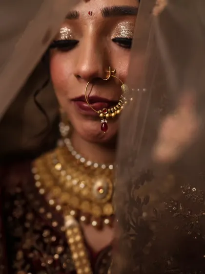 An artistic shot of my bride, peeking through her veil. The glitter on her eyes catches the light beautifully, adding a touch of magic to her look.