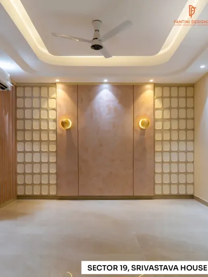 An empty bedroom in the Srivastava House project, showcasing the beautiful wall paneling and ceiling design before furniture placement. The built-in sconces and textured central panel create a ready-made feature wall.