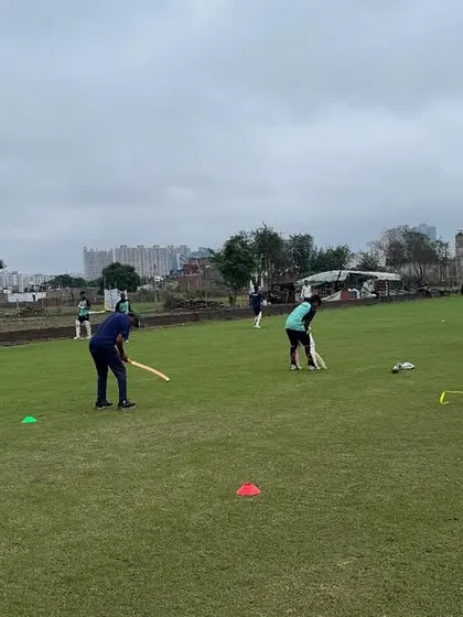 Training drills are designed to simulate match conditions and improve team coordination. Players engage in a fielding drill, honing their agility and teamwork under the watchful eye of our coaching staff.
