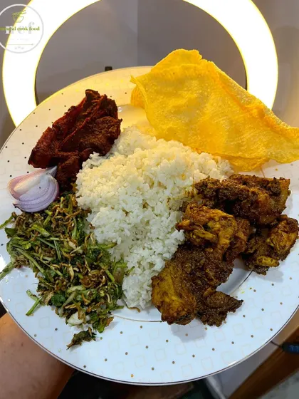 A simple yet satisfying meal of stir-fried chicken, singju, fried pork ribs, and crispy papad.