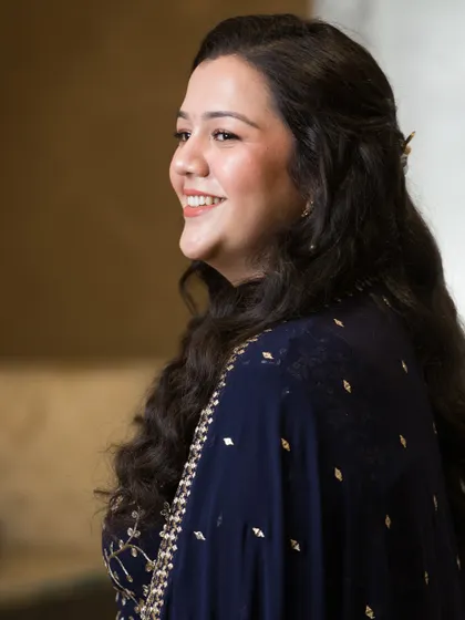 A candid side profile. The soft waves and natural makeup create a look of effortless elegance for her pre-wedding function.