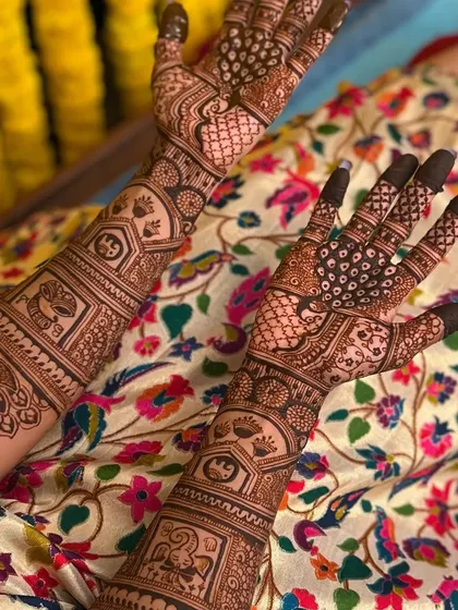 A close-up of Sahana's palm designs, featuring peacocks and personalized initials.