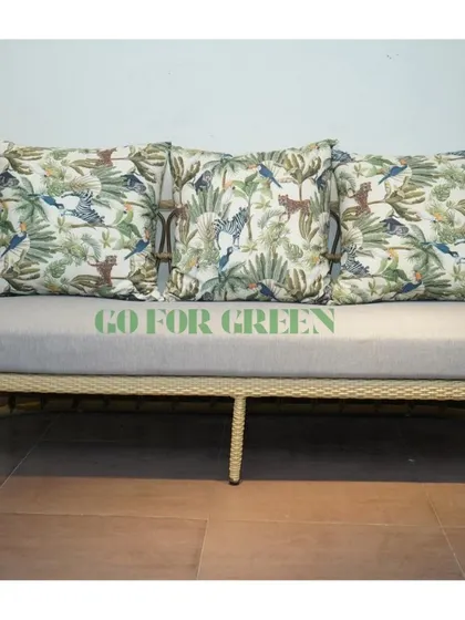 A closer look at our rattan-style sofa with custom jungle-themed cushions. The frame's gentle curves and the soft grey seat provide a comfortable and stylish foundation for your outdoor decor.
