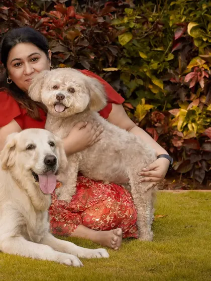 Focusing on the woman and her two dogs, this shot highlights her connection with both of them.
