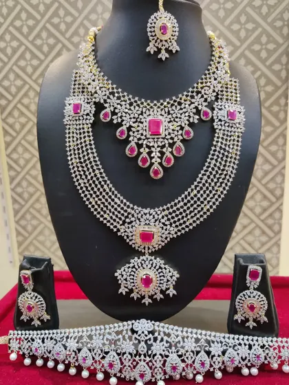 A full view of the American diamond and ruby bridal set, including the choker, layered haram, and vaddanam.