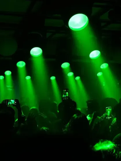 The entire club lit up in green, with beams of light cutting through the haze. An atmospheric shot from the Thalapathy celebration.