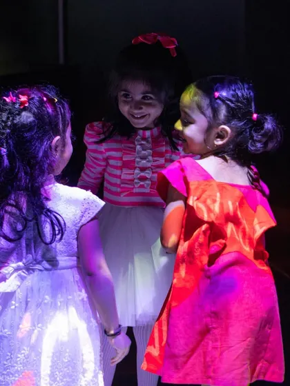 A huddle of friends sharing secrets and smiles on the interactive floor. These are the moments they'll remember.