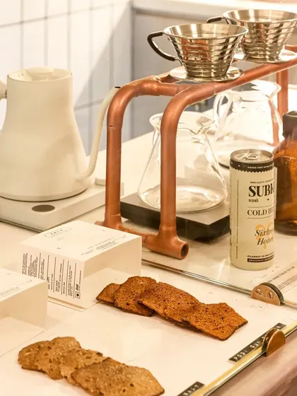 A close-up of the pour-over coffee station at Subko, featuring copper details that add a touch of warmth and craft to the minimalist setup.