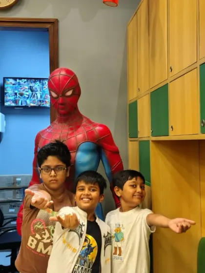 A group of friends pose with a life-sized Spider-Man statue. Our venue is filled with fun details and photo spots that kids love.