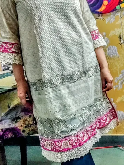 A full view of a beautiful Hakoba kurta with embroidered and lace-trimmed borders. This piece is perfect for summer, offering a breathable fabric with elegant detailing.