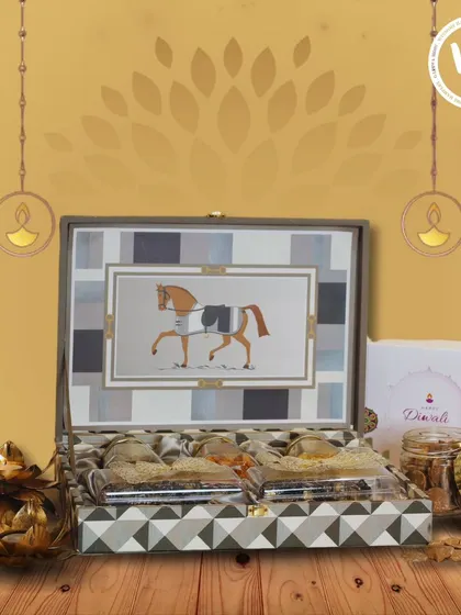 A uniquely designed gift box featuring an elegant horse motif, perfect for a distinguished Diwali present. The box opens to reveal a curated selection of Indian sweets and savories, blending traditional tastes with artistic packaging.