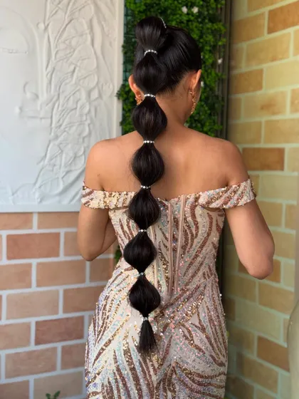 This modern bubble braid, also called a balloon ponytail, is a chic and stylish alternative to a traditional braid. I added small pearl bands to define each section for an elegant finish.