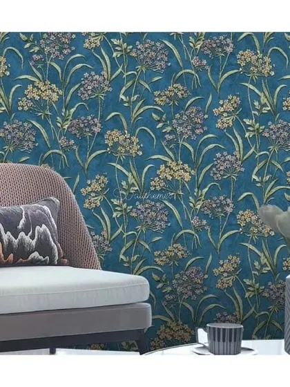 A modern living room with a deep blue wildflower wallpaper, creating a sophisticated and moody accent wall.