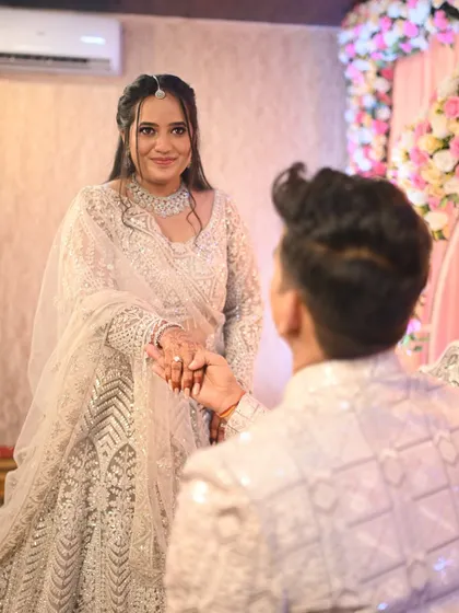 Another angle of this sweet moment. The bride's makeup looks flawless, with a focus on enhancing her natural beauty.