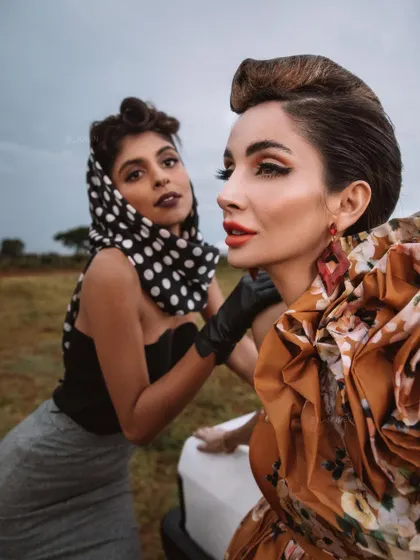 An intimate two-shot from the 'BLANCH' editorial. The composition and styling focus on the interaction between the characters, using their contrasting outfits to build a narrative of friendship or rivalry.