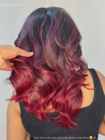 A close up of the texture and color of this fiery red look. The blend from dark roots to bright ends is seamless.