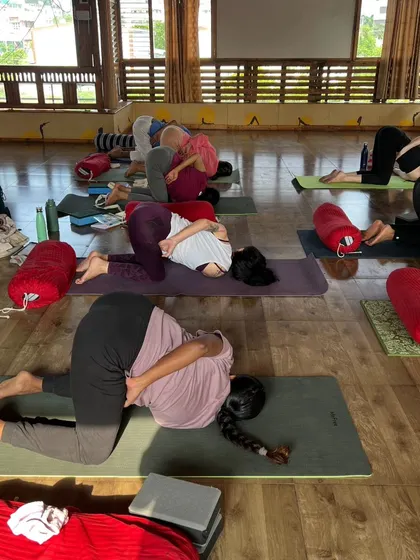Students hold a deep, passive twist in a Yin class, using the long hold to target connective tissues.
