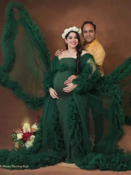 A stunning couple's portrait featuring our dramatic green ruffled gown. The partner's presence adds a layer of intimacy and support to this powerful, high-fashion look.