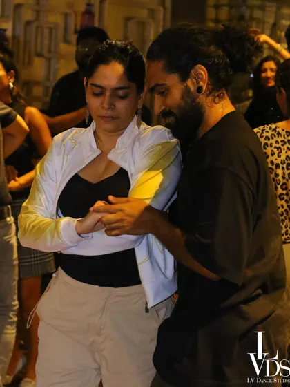 Two dancers in a close embrace, focused on the music. This image captures the intensity and connection of dances like Kizomba and sensual Bachata.