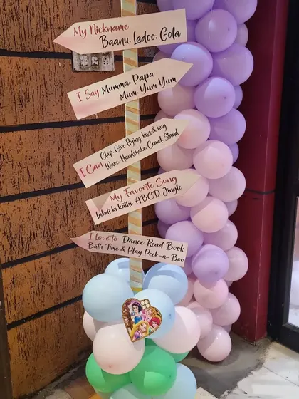 A personalized milestone sign for a first birthday party. This cute detail shares fun facts about the birthday girl.