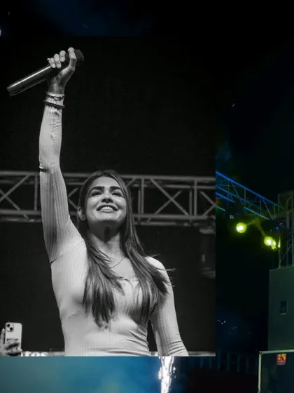 A powerful black and white shot of me with my hand raised high at Rangrez 2025. This captures the triumphant, unifying spirit of a great music festival.
