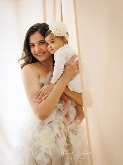 A tender embrace between a mother and her baby. The soft lighting and gentle expressions make this a warm and loving portrait.
