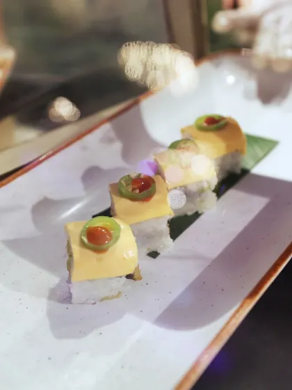 A delicate sushi creation, topped with a slice of jalapeño for a spicy kick. We enjoy creating fusion dishes that surprise and delight the palate.