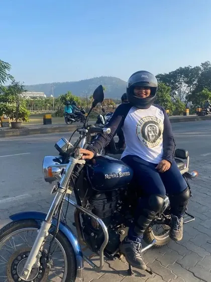 A graduate on her bike, wearing the Heels on Wheels jersey. She is a proud member of our riding tribe.