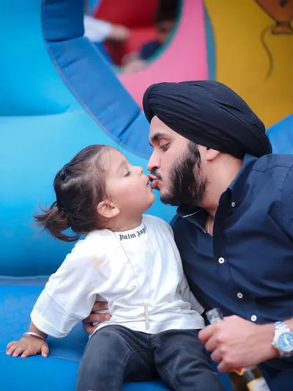 A father's sweet kiss for his son. These candid, affectionate moments are what make family photography so meaningful.