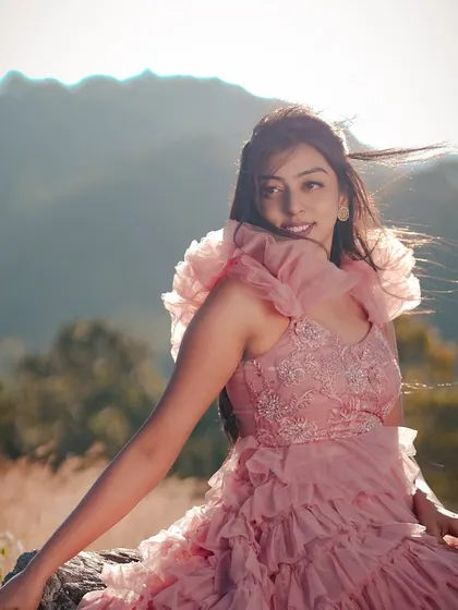 A solo portrait of the bride-to-be during a pre-wedding shoot on a hillside, her hair gently blowing in the wind. We make sure to capture beautiful individual portraits during your engagement session.