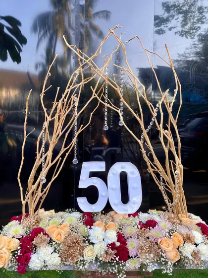 Another look at the 50th birthday floral centerpiece, this time with the marquee numbers turned off to show the beautiful mix of flowers and the golden branches.