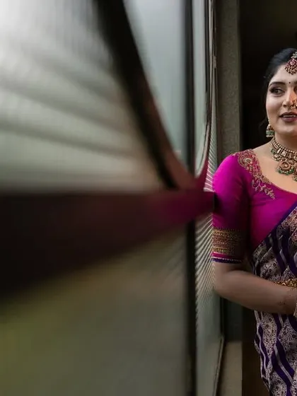 A wide, atmospheric shot of a bride-to-be in a long corridor. The dramatic lighting and leading lines create a cinematic and moody portrait.