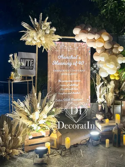 The welcome sign at night, with uplighting creating a dramatic and elegant entrance for the 40th birthday celebration.