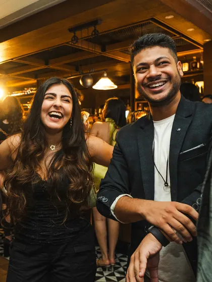 Sharing a laugh with a guest at the Hendrick's Gin show. My style is interactive and fun, ensuring that the entertainment feels like a natural part of the party.