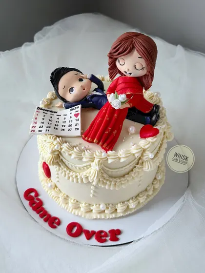 Game over! A fun, non-fondant bachelorette cake with vintage piping and a humorous, handcrafted figurine of the bride and groom.