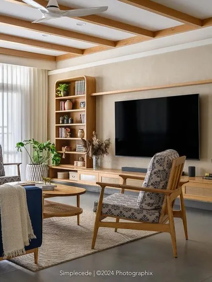 The 'Cover me in Sunshine' living room showcases our modern cottage style. We used graceful arches to shape entryways and a mix of curves and straight lines in the TV unit, while ceiling rafters add character against the muted beige walls.