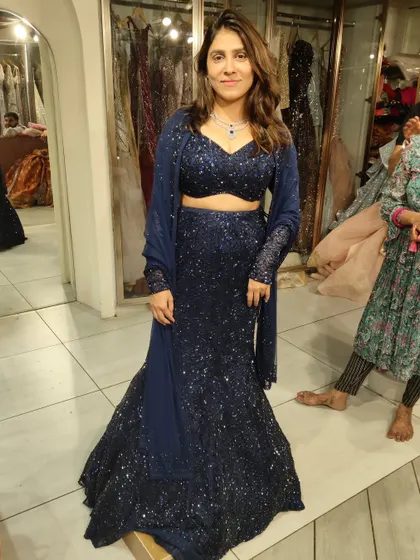 This client looks so chic in our navy blue sequin fish-cut lehenga. It's a popular choice for receptions and cocktail parties.