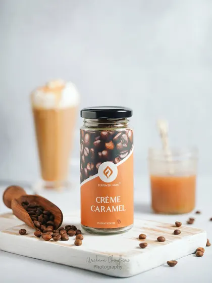 A clean, bright product shot focusing on the Crème Caramel coffee jar. This type of image is essential for e-commerce, showcasing the product with its ingredients in a fresh and appealing setting.