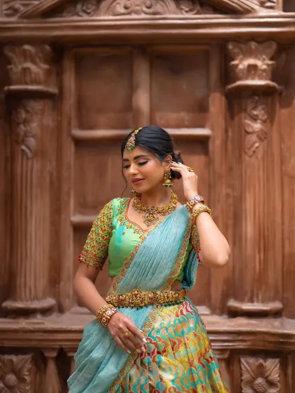 A candid moment of adjustment. This shot feels natural and unstaged, capturing the bride as she perfects her look.