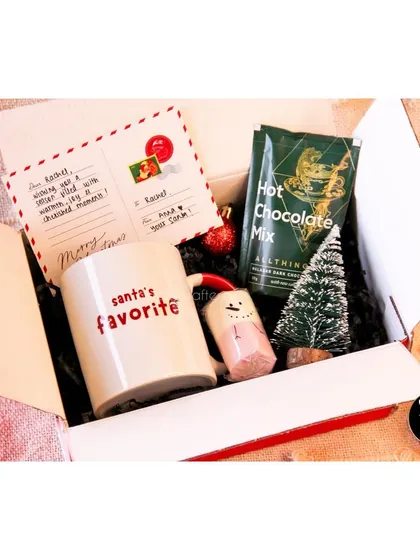 Our 'Hug in a Box' Christmas hamper is perfect for sending warm wishes, complete with a mini tree and hot cocoa.