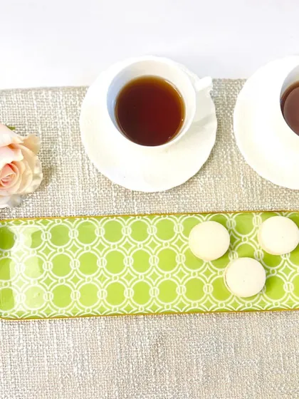 For a more modern look, this long tray features a bright green geometric pattern. It is a fun and vibrant piece for serving drinks or appetizers.