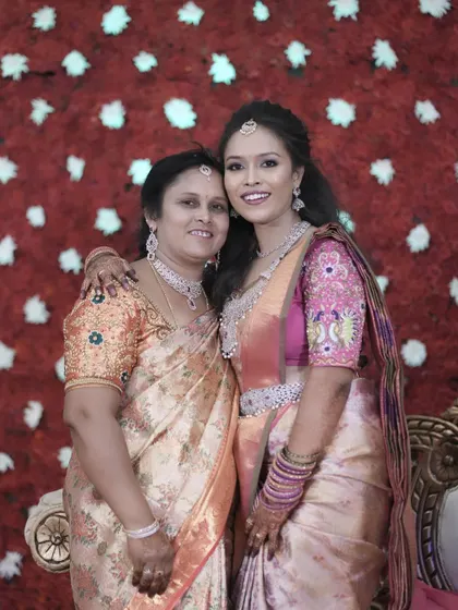 A heartwarming photo of the bride with her mother, both looking beautiful.